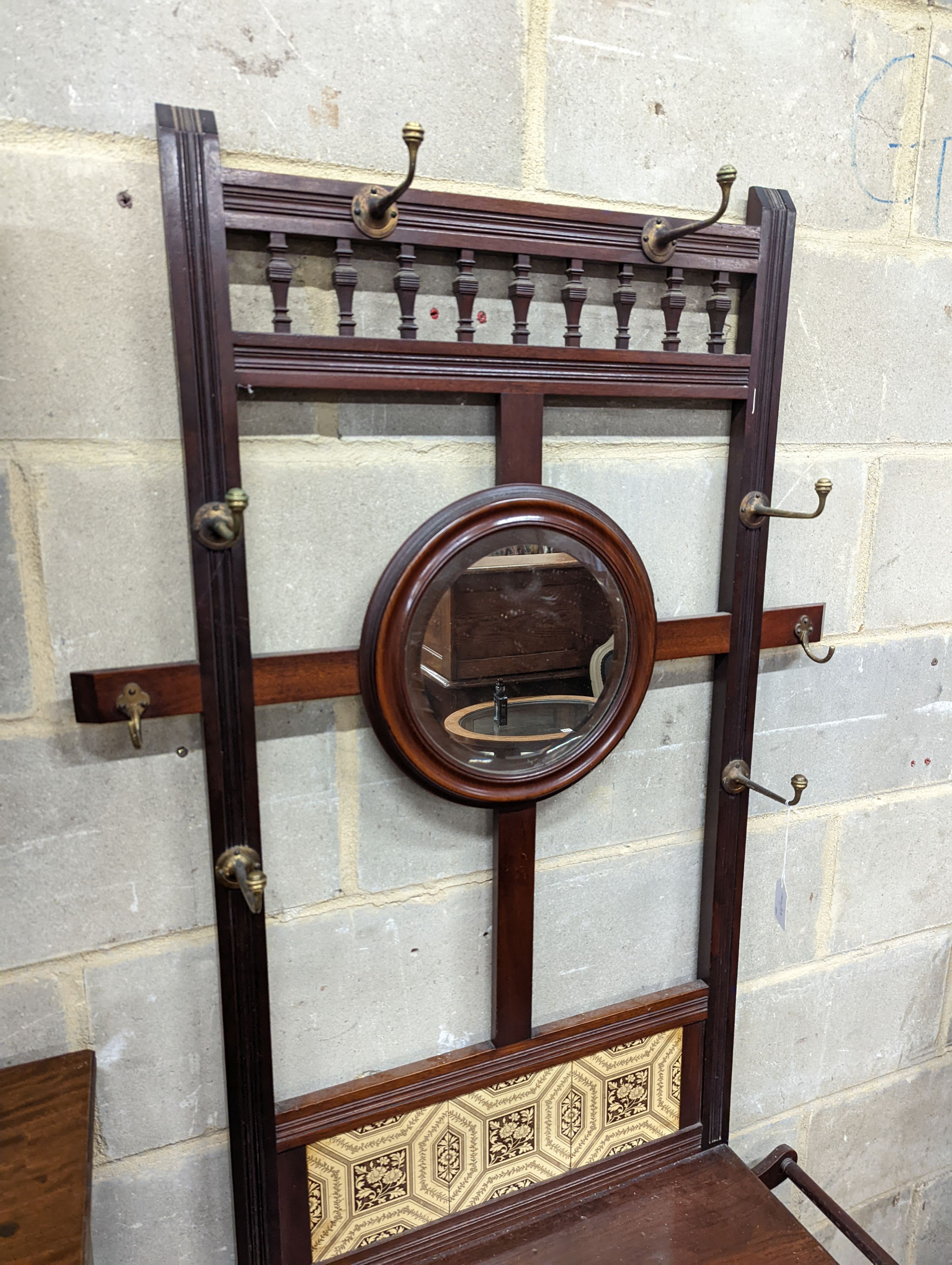 A late Victorian tile-backed mahogany wash stand, width 84cm, depth 34cm, height 184cm